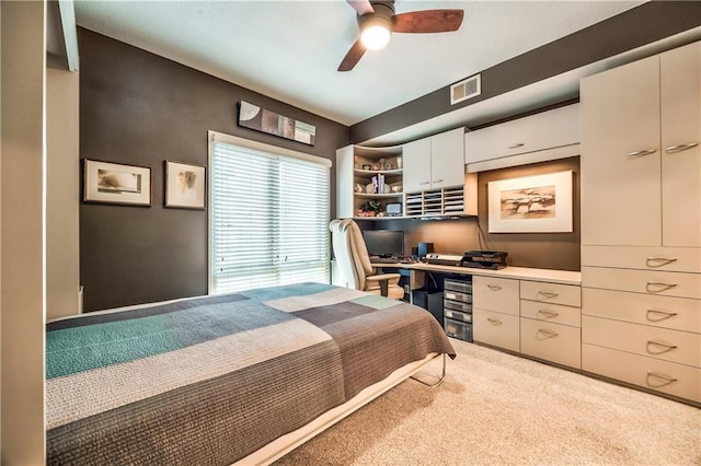 4949 Wornall Rd Unit 203, Kansas City, MO 64112 - carpeted bedroom featuring built in desk, visible vents, and a ceiling fan