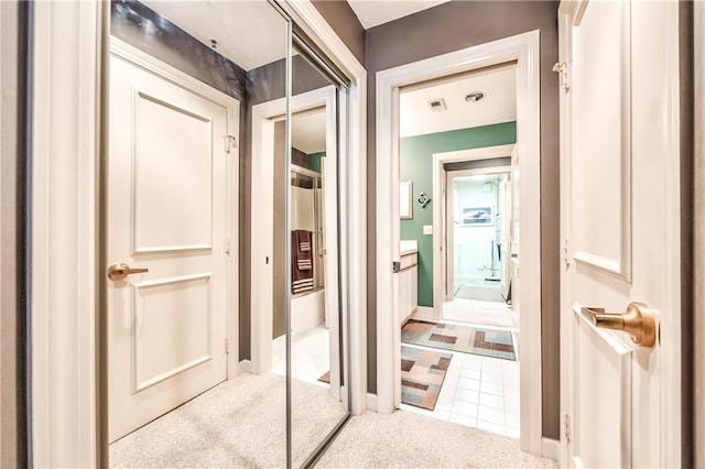 4949 Wornall Rd Unit 203, Kansas City, MO 64112 - corridor with tile patterned flooring, visible vents, and carpet