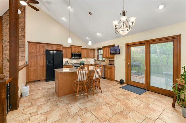 2501 Olde Creek Ct S, Leavenworth, KS 66048 - kitchen with appliances with stainless steel finishes, a center island, brown cabinets, ceiling fan, and backsplash