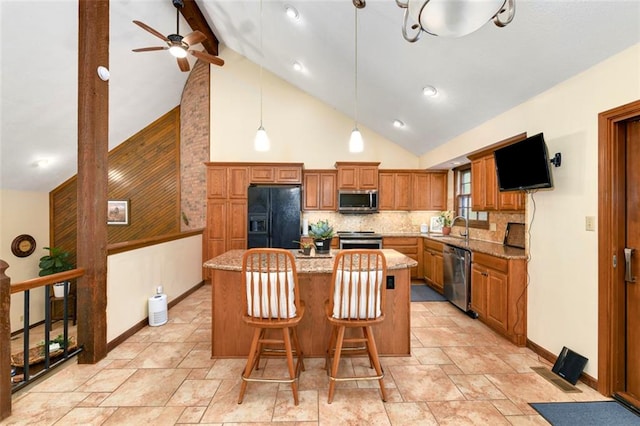 2501 Olde Creek Ct S, Leavenworth, KS 66048 - kitchen featuring high vaulted ceiling, a center island, a ceiling fan, appliances with stainless steel finishes, and tasteful backsplash