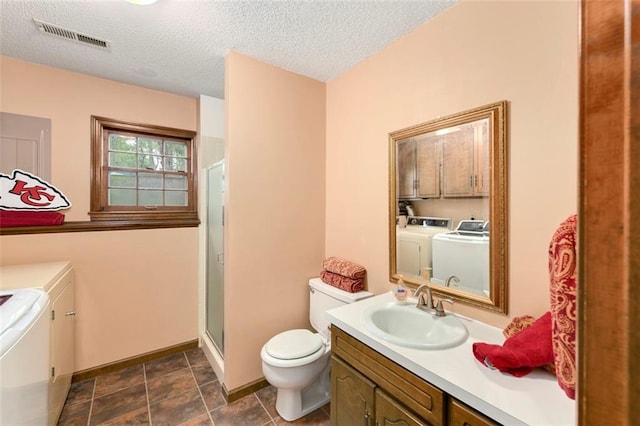 2501 Olde Creek Ct S, Leavenworth, KS 66048 - bathroom with separate washer and dryer, vanity, a stall shower, and a textured ceiling