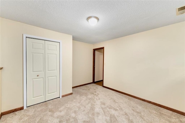 2501 Olde Creek Ct S, Leavenworth, KS 66048 - unfurnished bedroom featuring light carpet, a closet, and a textured ceiling