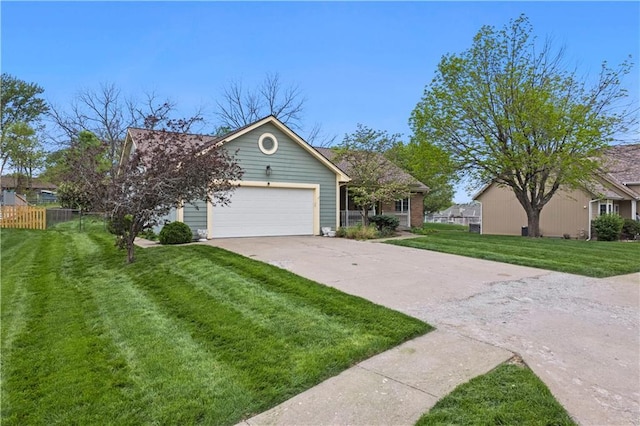 view of front of home with fence, an attached garage, concrete driveway, and a front lawn