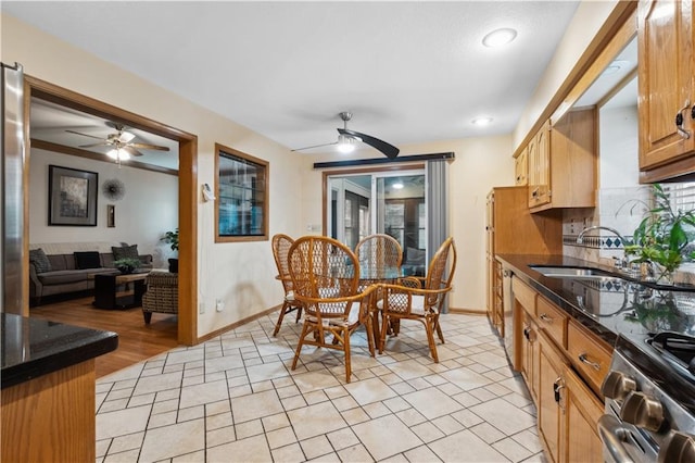dining area with baseboards and a ceiling fan