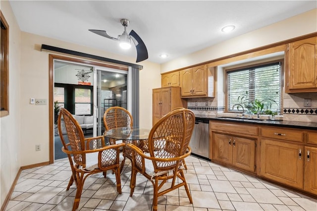 kitchen featuring decorative backsplash, ceiling fan, dishwasher, and dark countertops