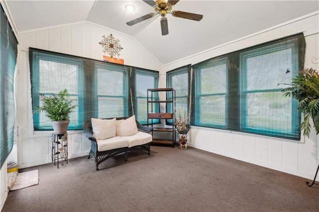 interior space featuring carpet flooring, a ceiling fan, vaulted ceiling, and a healthy amount of sunlight