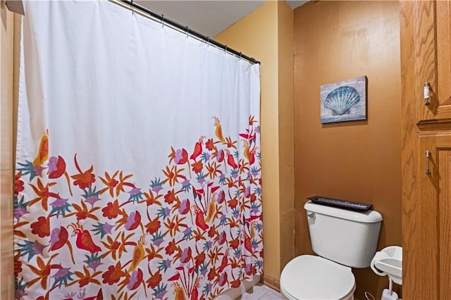 bathroom with toilet and curtained shower