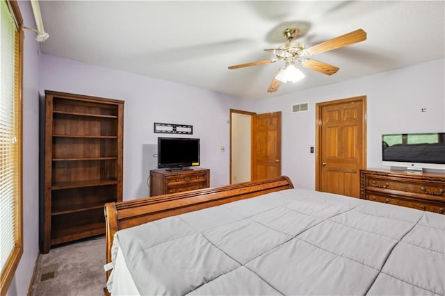 bedroom with visible vents, a ceiling fan, and carpet