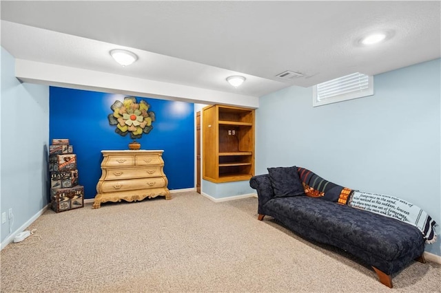 sitting room featuring carpet floors, baseboards, and visible vents
