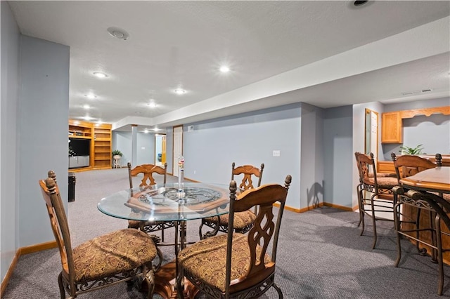 carpeted dining space with baseboards and recessed lighting