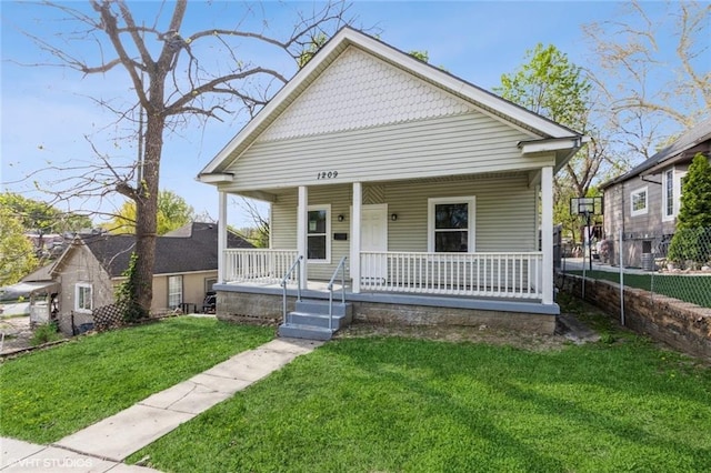 1209 Lowell Ave, Kansas City, KS 66102 - bungalow-style home featuring fence, a porch, and a front yard