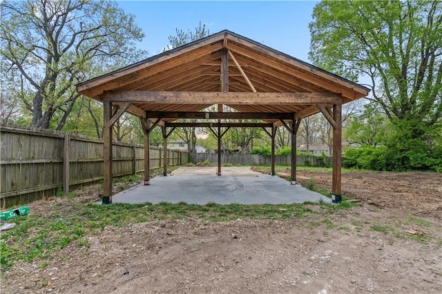surrounding community with a fenced backyard, a gazebo, a carport, and a patio area