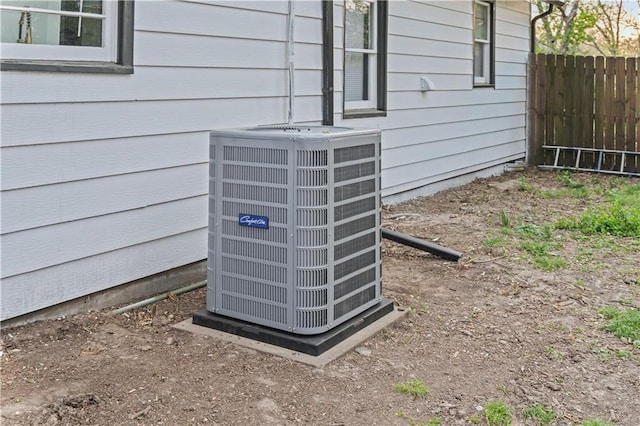 details featuring central AC unit and fence