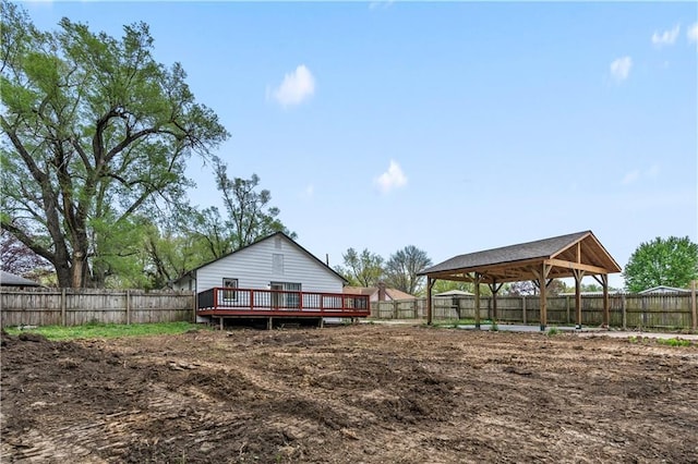rear view of house with a gazebo, a wooden deck, and a fenced backyard