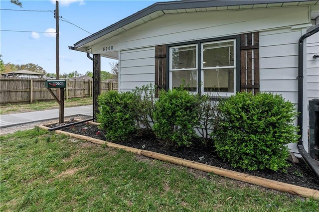 view of side of property featuring fence