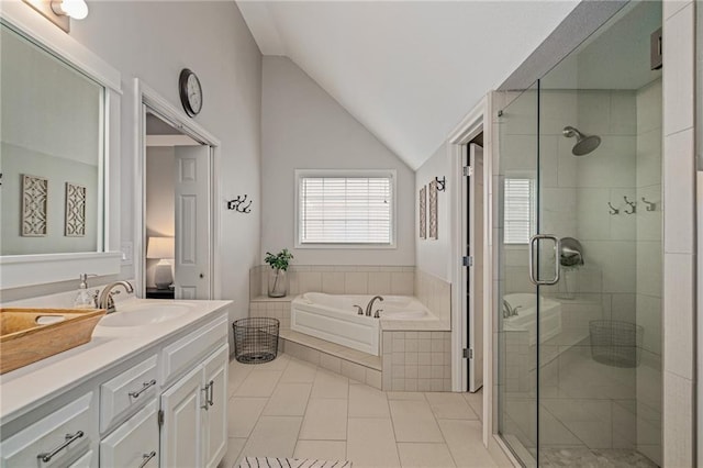 bathroom featuring tile patterned flooring, vanity, a shower stall, vaulted ceiling, and a bath