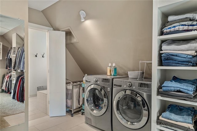 laundry room featuring tile patterned floors, laundry area, and washer and dryer