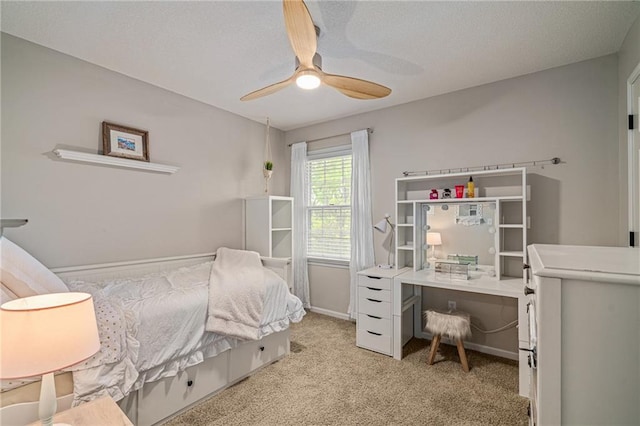 bedroom featuring baseboards, carpet flooring, a textured ceiling, and a ceiling fan
