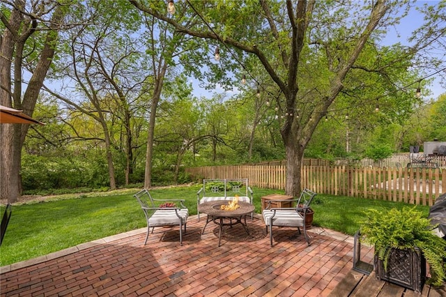 view of patio with a fire pit and fence