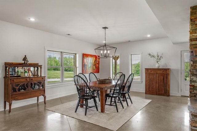 dining space featuring concrete floors, baseboards, a chandelier, and recessed lighting