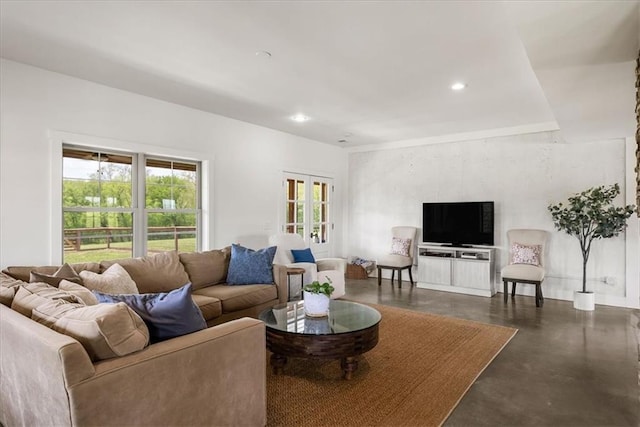 living area with finished concrete floors and recessed lighting