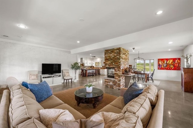 living area with finished concrete floors, recessed lighting, and baseboards