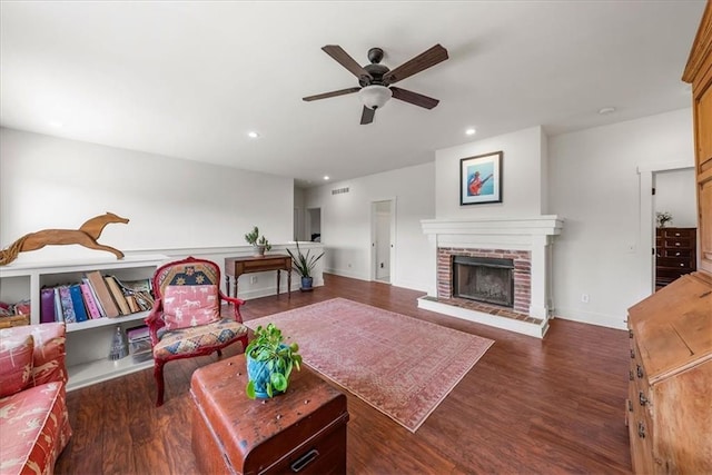living room featuring ceiling fan, wood finished floors, a brick fireplace, recessed lighting, and baseboards
