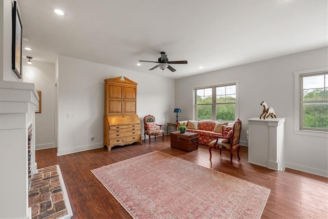 living area featuring plenty of natural light, ceiling fan, dark wood-type flooring, and recessed lighting