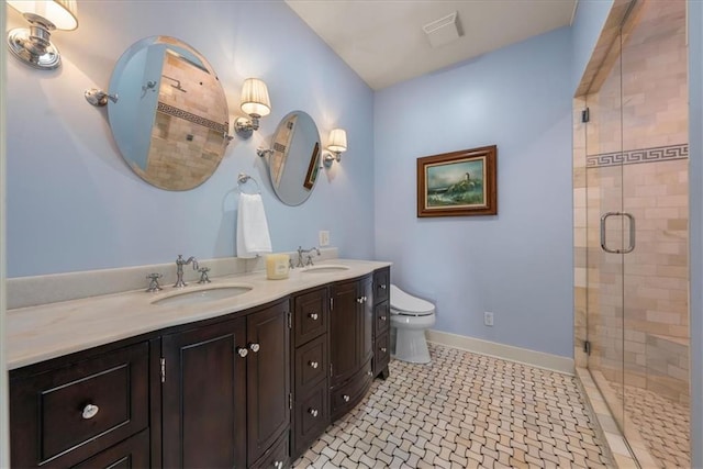 full bathroom with a shower stall, toilet, double vanity, and baseboards