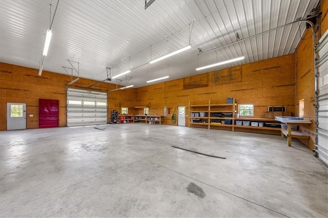 garage with a workshop area and wooden walls