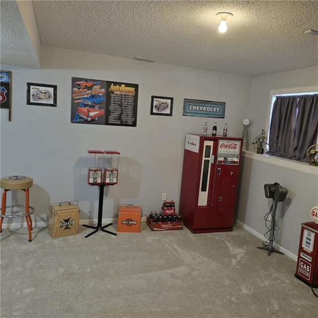 recreation room with a textured ceiling, baseboards, and carpet floors