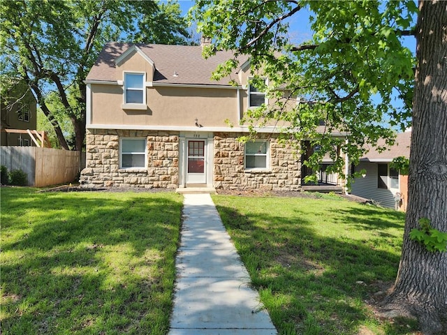 multi unit property with stone siding, stucco siding, a chimney, and roof with shingles