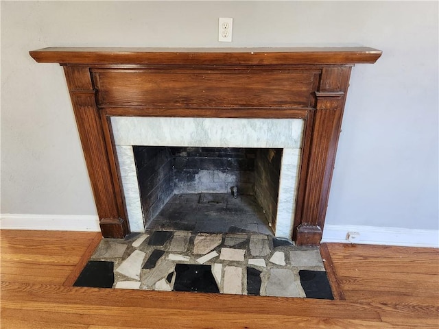 detailed view of a fireplace with flush hearth and baseboards