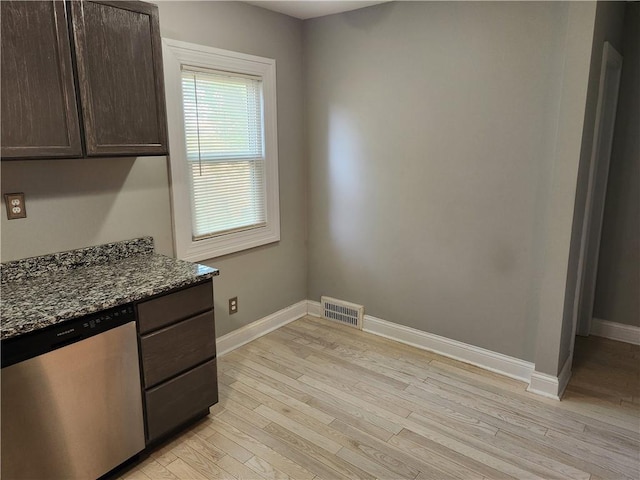 unfurnished dining area with baseboards and light wood-type flooring