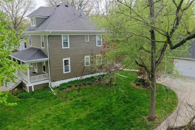 1420 N Mulberry St, Maryville, MO 64468 - rear view of house with covered porch, a yard, and a shingled roof