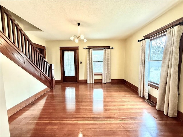 1420 N Mulberry St, Maryville, MO 64468 - foyer entrance with plenty of natural light, wood finished floors, stairs, a chandelier, and a textured ceiling