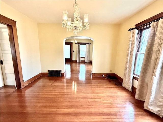 1420 N Mulberry St, Maryville, MO 64468 - unfurnished dining area with arched walkways, wood finished floors, and a chandelier
