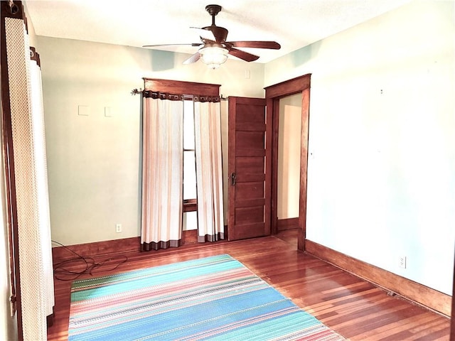 1420 N Mulberry St, Maryville, MO 64468 - spare room with wood finished floors, ceiling fan, and baseboards