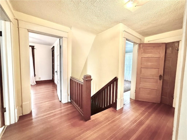 1420 N Mulberry St, Maryville, MO 64468 - hall with an upstairs landing, wood finished floors, and a textured ceiling