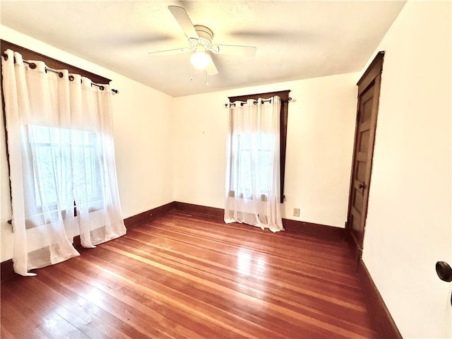 1420 N Mulberry St, Maryville, MO 64468 - unfurnished bedroom featuring wood-type flooring, baseboards, and ceiling fan