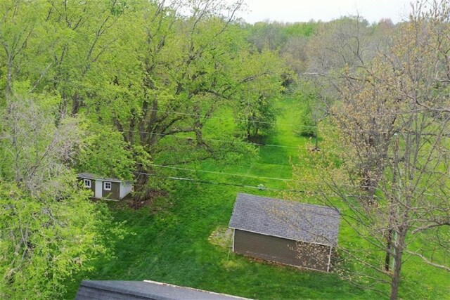 1420 N Mulberry St, Maryville, MO 64468 - aerial view of property and surrounding area with a heavily wooded area