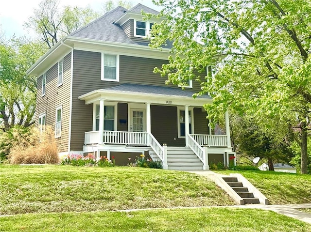 1420 N Mulberry St, Maryville, MO 64468 - traditional style home featuring covered porch, a front yard, stairway, and a shingled roof