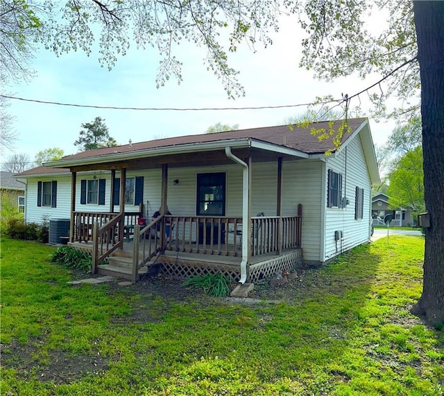802 Cherry St, Lamar, MO 64759 - view of front of property featuring covered porch, central air condition unit, and a front lawn