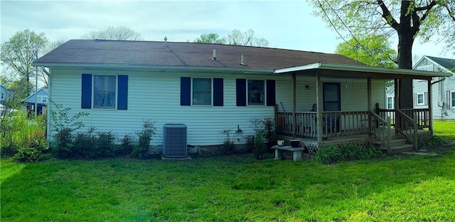 802 Cherry St, Lamar, MO 64759 - rear view of house featuring a porch, a lawn, and cooling unit