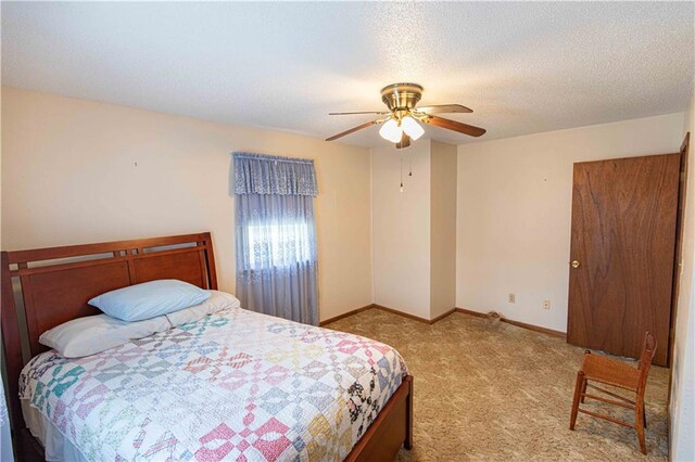 802 Cherry St, Lamar, MO 64759 - bedroom with baseboards, carpet flooring, a textured ceiling, and ceiling fan