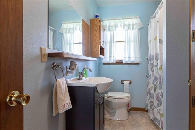 802 Cherry St, Lamar, MO 64759 - full bathroom with vanity, a shower with curtain, and toilet