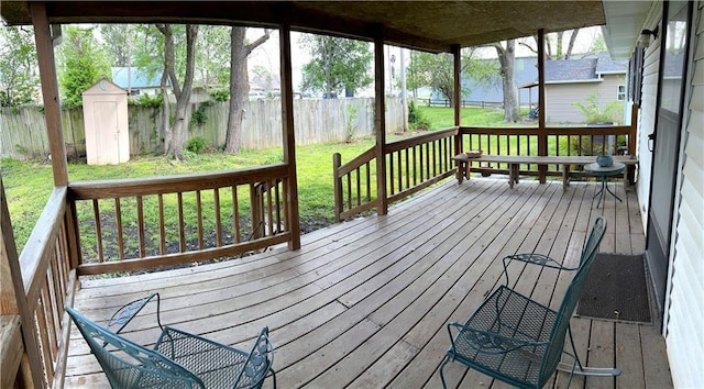 802 Cherry St, Lamar, MO 64759 - wooden deck with a fenced backyard, an outdoor structure, and a yard