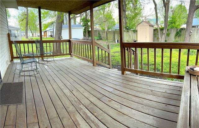 802 Cherry St, Lamar, MO 64759 - wooden terrace with a residential view, an outdoor structure, a fenced backyard, a storage unit, and a yard