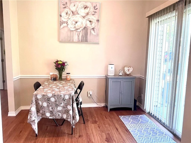 428 W Sycamore St, Nevada, MO 64772 - dining space with baseboards and wood finished floors