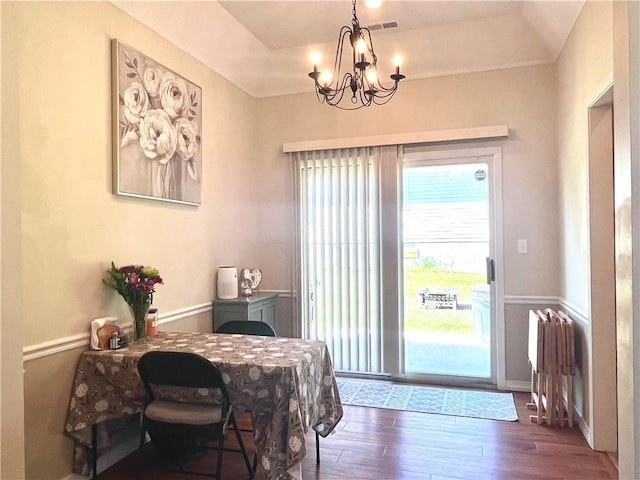 428 W Sycamore St, Nevada, MO 64772 - dining space featuring a chandelier, wood finished floors, and radiator heating unit